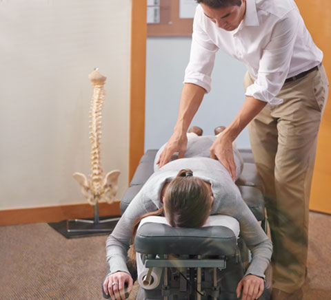 Man being adjusted by Chiropracticor